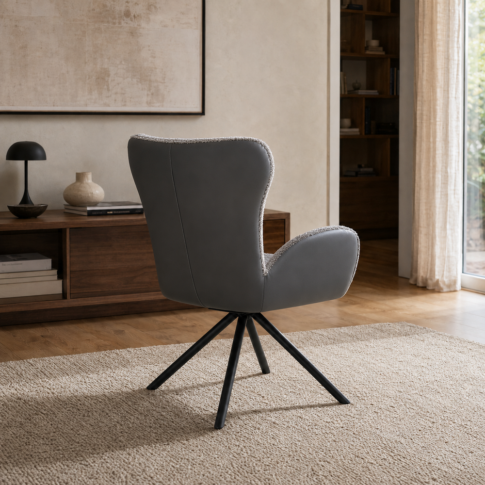 Vista posterior del Sillón Niva tapizado íntegramente en ecocuero gris oscuro con base de patas metálicas.