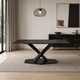 Mesa de comedor Cross Black Marquina con tapa rectangular negra y base central en X sobre una alfombra clara.