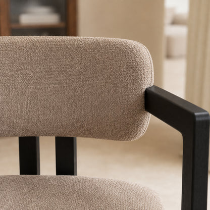 Primer plano de la textura del tejido chenille taupe en el respaldo curvo de la silla Besaya.
