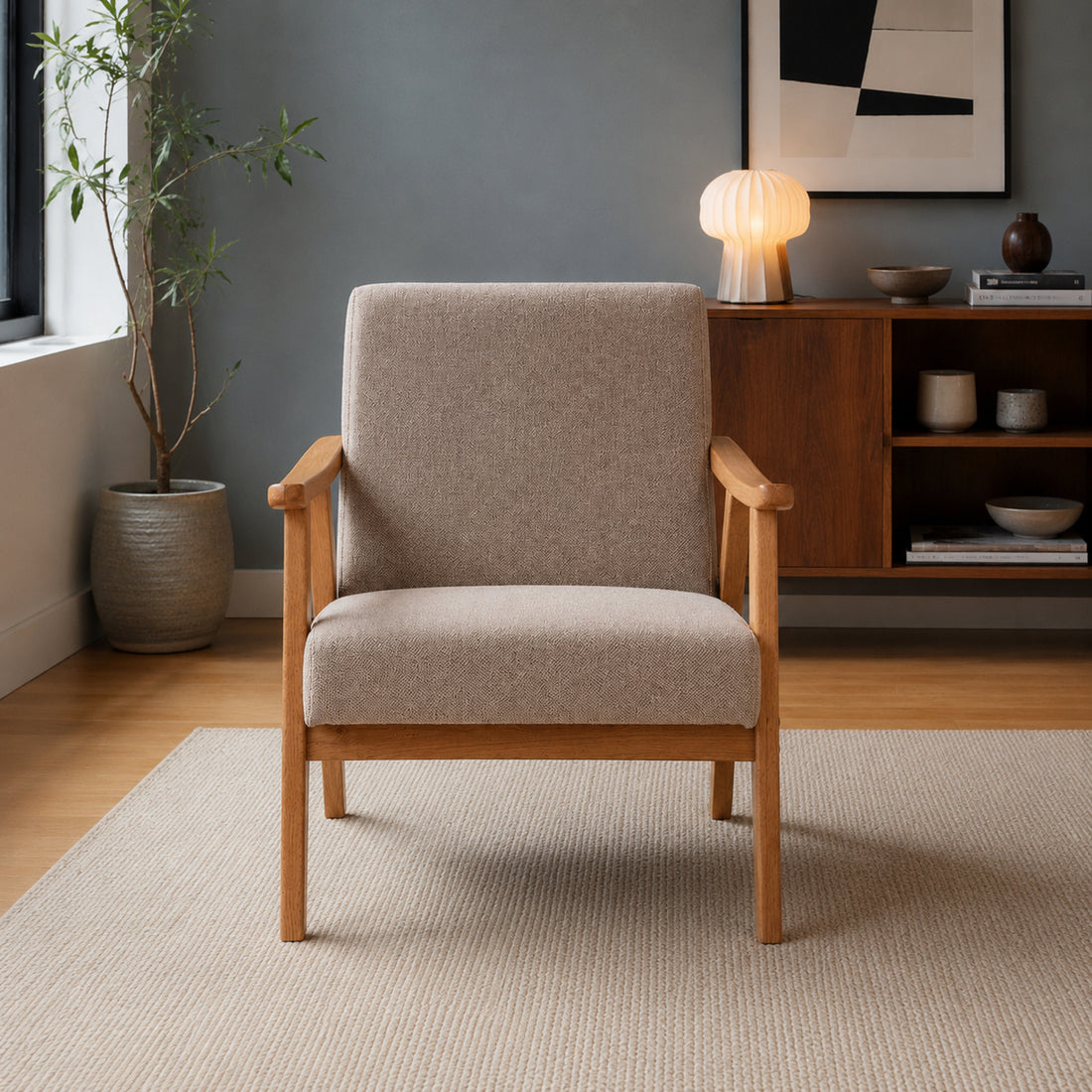 Vista frontal del sillón Laurel tapizado en chenille color taupe y estructura de madera natural.